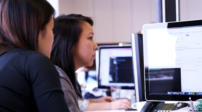 Two women looking at a computer monitor